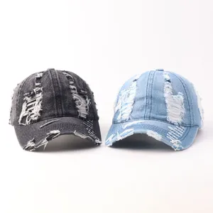 Close-up detail view of distressed denim baseball caps showing ripped texture and stitching.