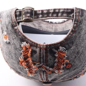 Distressed denim baseball cap back detail, vintage washed fabric, adjustable metal buckle.