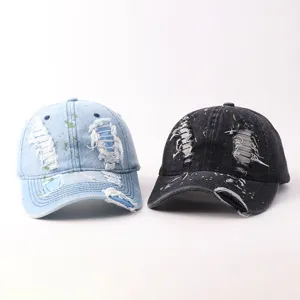 Unisex distressed denim baseball cap with stylish graffiti and ripped details for summer wear.