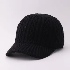Closeup of a black knitted baseball cap, soft woolen material with classic texture detail.