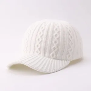 Detailed view of white knit baseball cap, soft cozy winter warm woolen hat, simple daily wear.