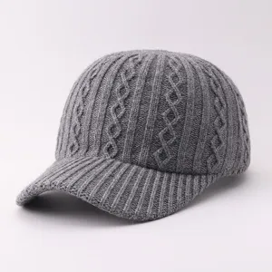 Grey cable knit baseball cap detail, soft warm winter hat with ribbed brim texture close up.