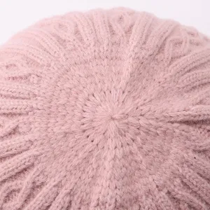 Close-up detail of the soft pink knit texture, showing fine cable pattern and warm wool weave.