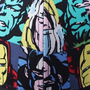 Detail view of comic superhero print baseball cap fabric, vibrant pop art style pattern.