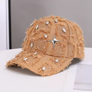 Detailed shot of trendy tweed-style fringe baseball cap with rhinestones and star charm.