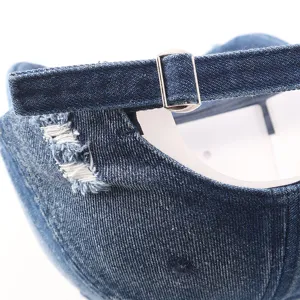 Close-up detail of distressed denim baseball cap back strap with metal adjustable buckle.
