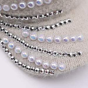 Close-up of winter knitted empty top hat with sparkling rhinestones and iridescent pearls.