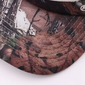Close-up detail of camouflage baseball cap brim, showcasing neat multi-row stitching and fabric.