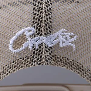 Casual mesh trucker hat detail view with embroidered text, breathable summer sun cap.