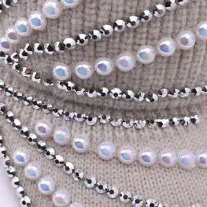 Close-up detail view of winter warm knitted hat featuring pearl and rhinestone decorations.