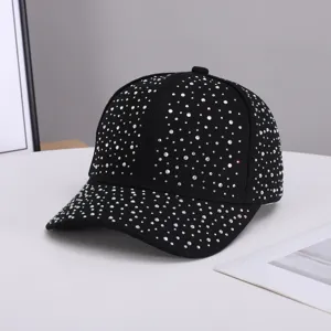 Close-up detail of a sparkling rhinestone-embellished black baseball cap surface.