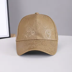 Detailed view of brown paisley printed faux leather baseball cap with curved brim.