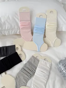 Detailed view of ballet style stirrup leg warmers in multiple solid colors, soft and breathable knit.