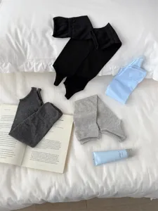 Detail shot of solid color ballet stirrup socks in multiple colors on a cozy bed setup.
