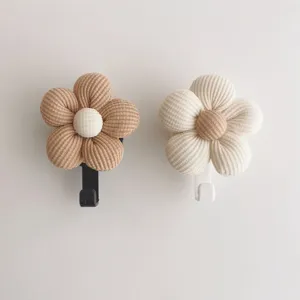 Detailed shot of two Korean style cute corduroy flower adhesive wall hooks in neutral tones.