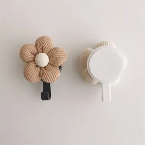 Detailed view of cute fabric flower wall hooks with adhesive backing for no-drill mounting