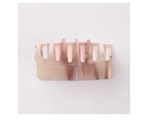 Detailed view of the transparent jelly-textured hair claw clip with multi-color streaks