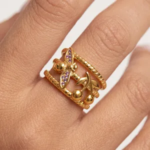 Macro detail of 18k gold plated stainless steel ring with bee and cherry motifs