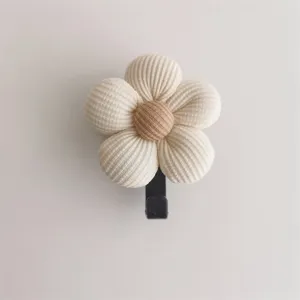 Close-up of a cute flower-shaped adhesive wall hook featuring waffle fabric texture