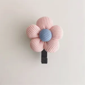 Close-up of cute pink ribbed fabric flower wall hook showing soft texture detail
