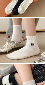 Close-up details of retro cat embroidered lace socks showing texture and cute style design.