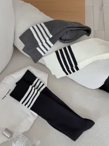 Ribbed long tube socks with classic multi-bar stripes design, comfortable knit fabric.