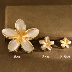 Detail view of 3 sizes of Plumeria flower hair claw clips for different hairstyles