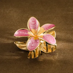 Detailed view of pink enamel plumeria flower hair claw clip with golden finish