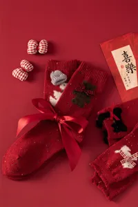 Red woolen women mid tube socks with cute bows and knit bear design for New Year winter warmth