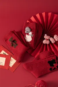 Red wool-blend festive mid-calf socks with cute 3D animal appliques and bow accents for New Year.