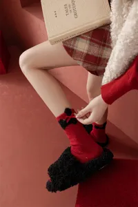 Red wool blend speckled yarn mid-tube women socks with cute plush bow accent for warm winter daily wear