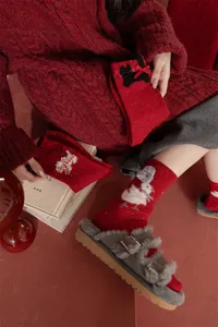 Detailed red wool winter socks with cute animal appliques for cozy festive daily wear.