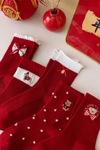 Red festive mid-calf socks for women featuring cute bow embroidery and New Year themes.