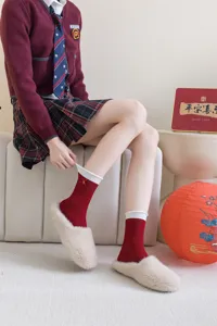 Red mid-calf socks for women, cute bow embroidery, cozy winter festive hosiery detail.