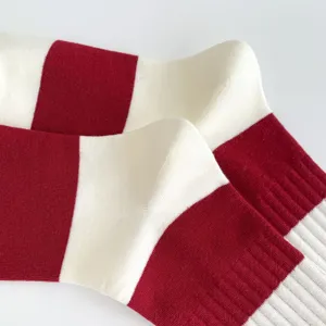 Burgundy and white striped mid-tube cotton socks, detailed knit texture, cozy autumn style.