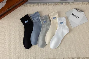 Detailed view of casual mid-calf cotton socks in five colors with stylish embroidery.