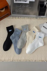 Men's casual mid-tube cotton socks with stylish letter embroidery, breathable and trendy.