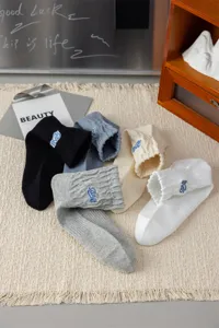 Men's stylish mid-tube cotton socks with chic blue embroidery, breathable, casual streetwear.