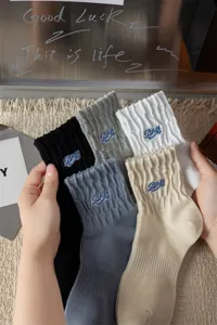 Men's mid-tube cotton socks with stylish letter embroidery, breathable and comfortable street style.