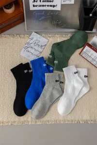 Men's combed cotton mid-tube socks with embroidered letter details, comfortable and stylish.