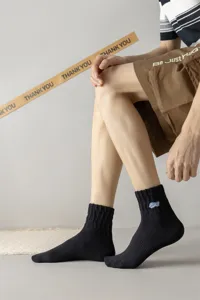 Men's cotton mid-tube sports socks with stylish letter embroidery for street fashion wear.