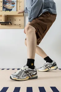 Men black mid-tube cotton socks with yellow embroidery lightning pattern for spring autumn.