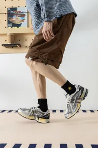 Men's mid-tube cotton socks featuring embroidered yellow lightning design for sporty daily wear.