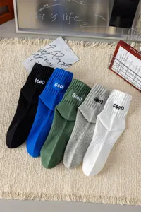 Men's combed cotton mid-calf socks with cute heel embroidery, comfortable solid color daily wear.
