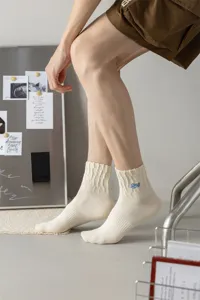Men's stylish mid-calf cotton socks with cable knit texture and cool side embroidery details for daily wear.