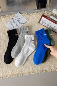 Close-up view of casual combed cotton mid-tube socks featuring ankle embroidery details.