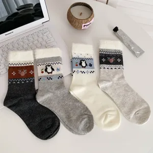 Detailed view of women's cozy winter fuzzy cuff socks featuring cute reindeer and penguin patterns.