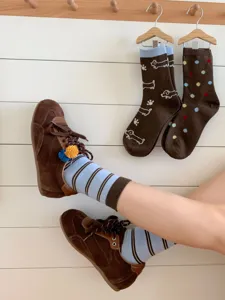 Cozy women's mid-calf socks detail featuring cute dachshund embroidery, polka dots and striped patterns.