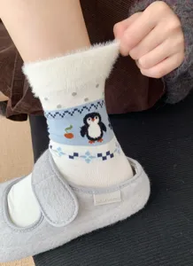 Women's fuzzy winter mid-tube socks featuring cute penguin and Fair Isle geometric patterns.