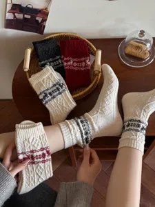 Vintage Christmas wool socks featuring cute elk and snowflake knit patterns, cozy winter warm crew socks.